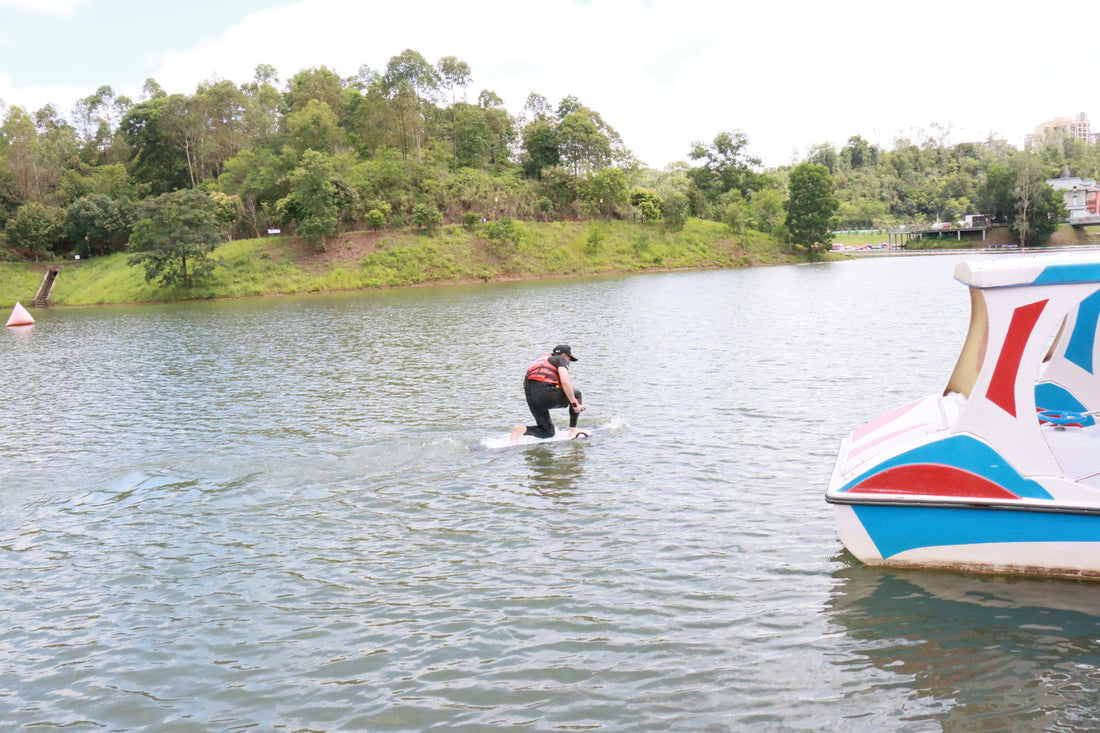 An electric hydrofoil enthusiast riding smoothly on a calm lake