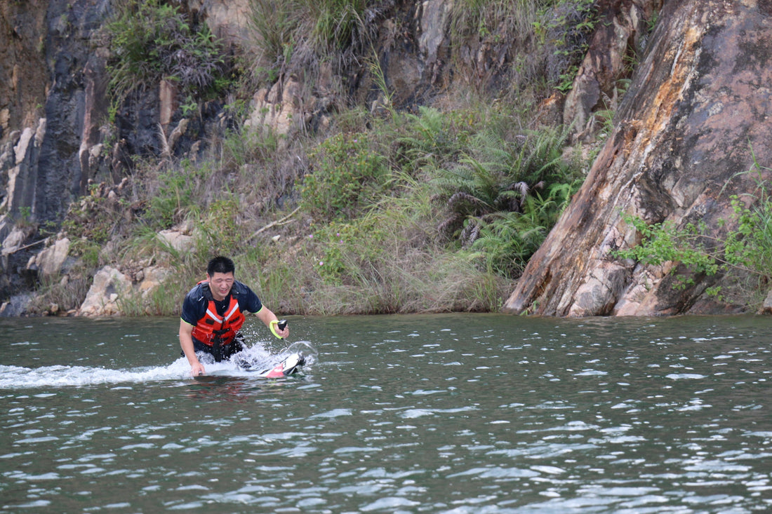 A rider on an electric hydrofoil losing balance and about to fall into the water.