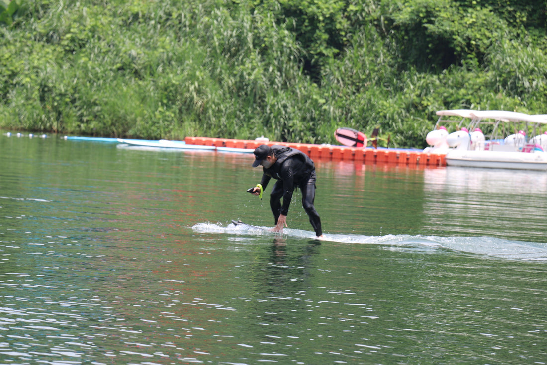 Rider soaring above clear waters on ASUFUN hydrofoil, showcasing freedom, balance, and innovative foiling technology.