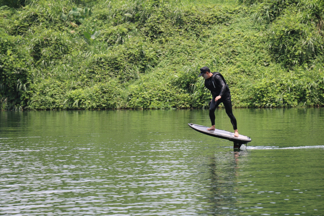 Riders enjoying ASUFUN electric hydrofoil boards at sunset, gliding smoothly above the water.