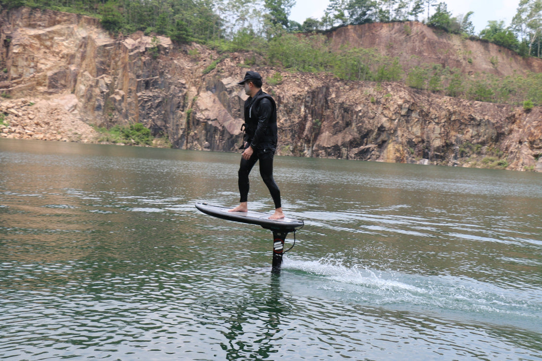 Rider using cheap hydrofoil board on calm water with electric propulsion