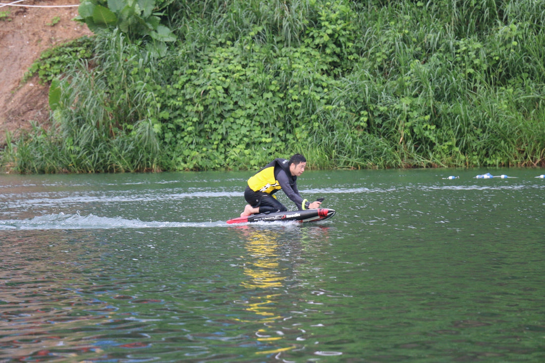 An electric hydrofoil beginner practicing on a calm lake, learning how hydrofoil works