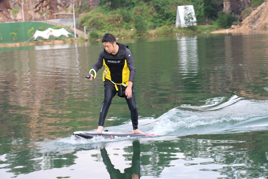 Wing foil for beginners riding an electric hydrofoil board on calm flat water