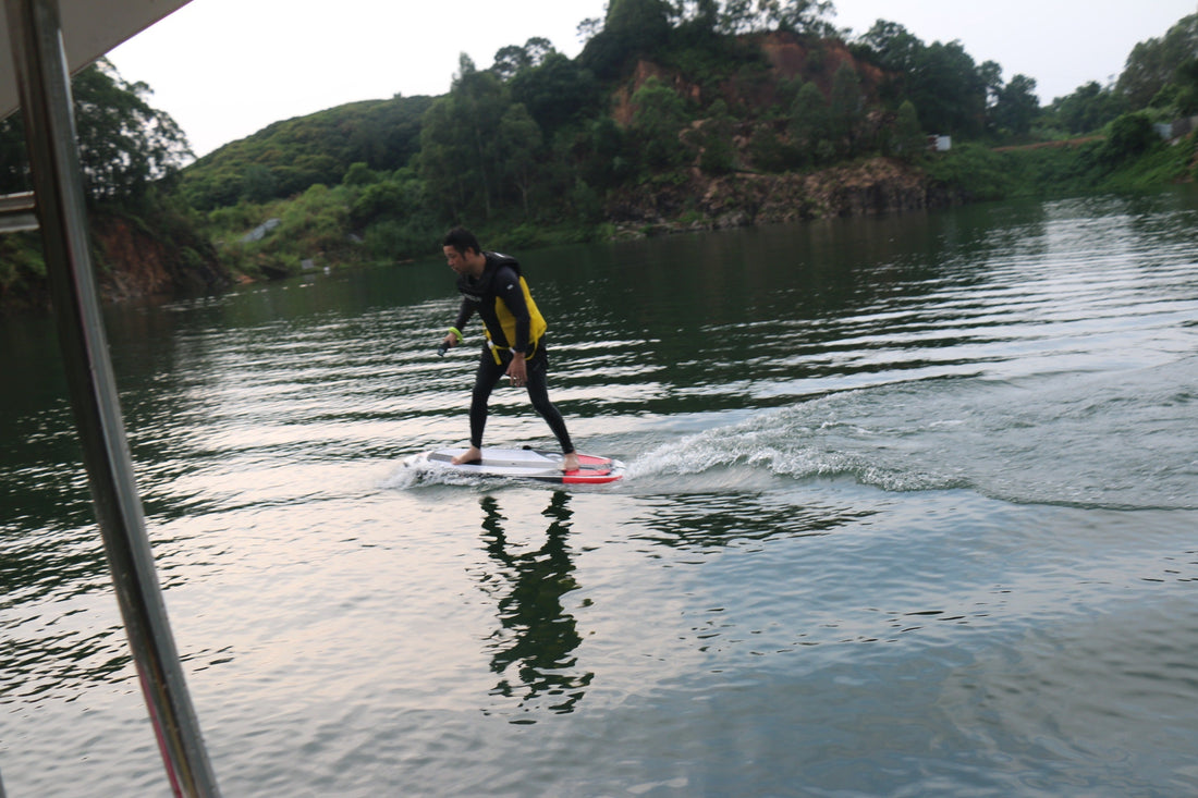 ASUFUN efoil rider gliding above water at sunset, showcasing the freedom and innovation of electric surfing.