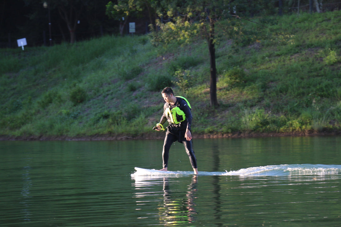 An electric hydrofoil enthusiast riding smoothly on a calm lake