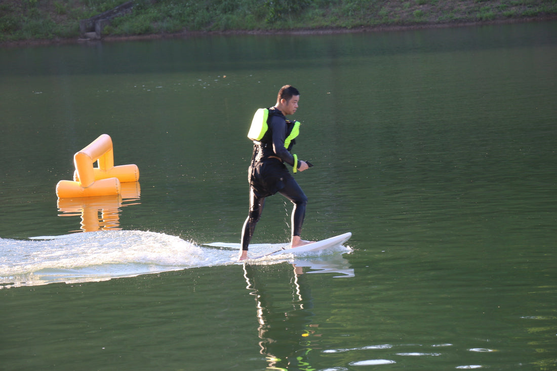 Rider gliding above water on an electric hydrofoil board, enjoying smooth flight.